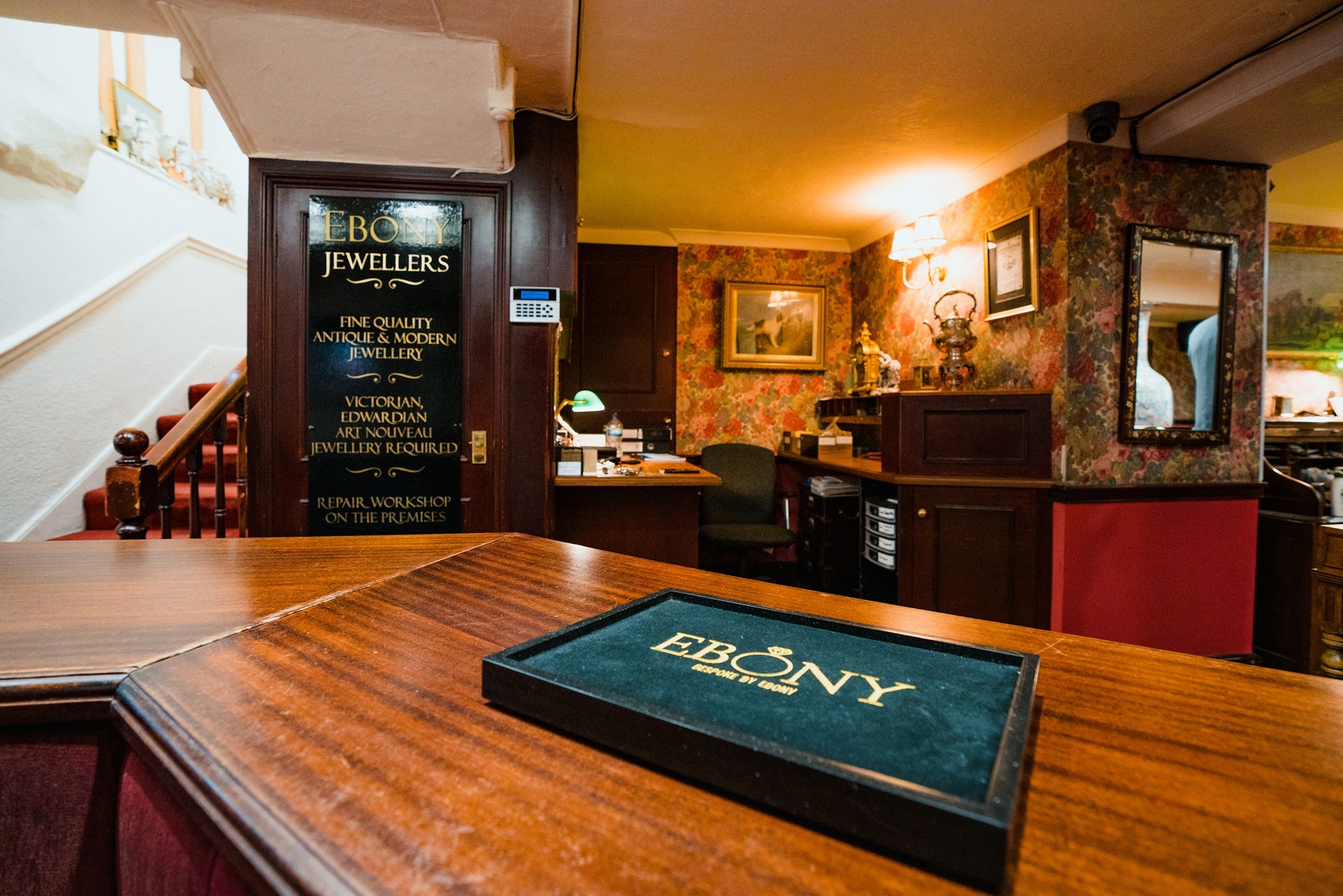 Interior of Ebony Jewellers with a wooden counter and 'Ebony' sign.